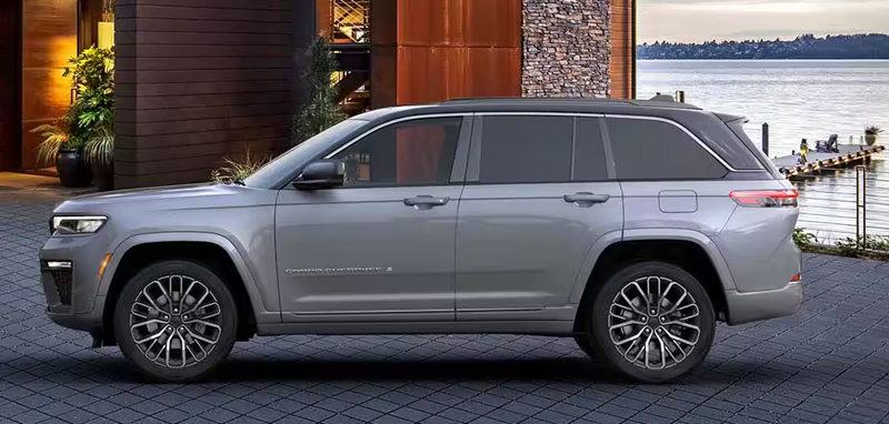Jeep Grand Cherokee parked in front of a house and waterfront